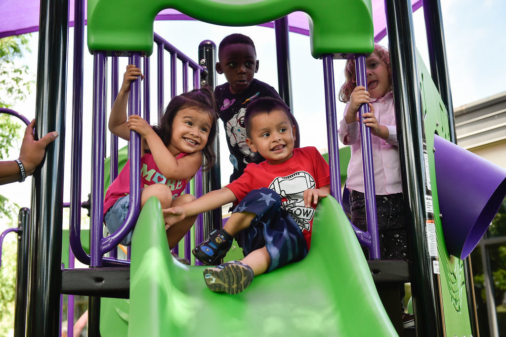 Children have fun on a newly built play area at Fred Moore Day Nursery School. Floyd Smith Concrete is the company that built the play area at Fred Moore Day Nursery School. The company is building it through a grant.
